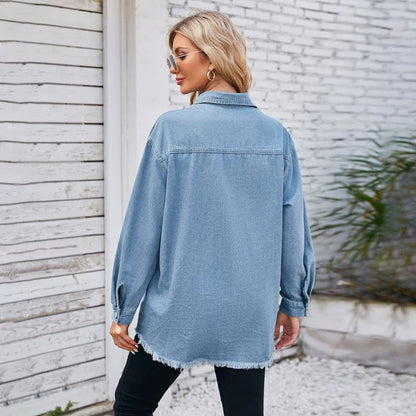 Women's oversized button down long sleeve denim shirt with frayed hem, back view
